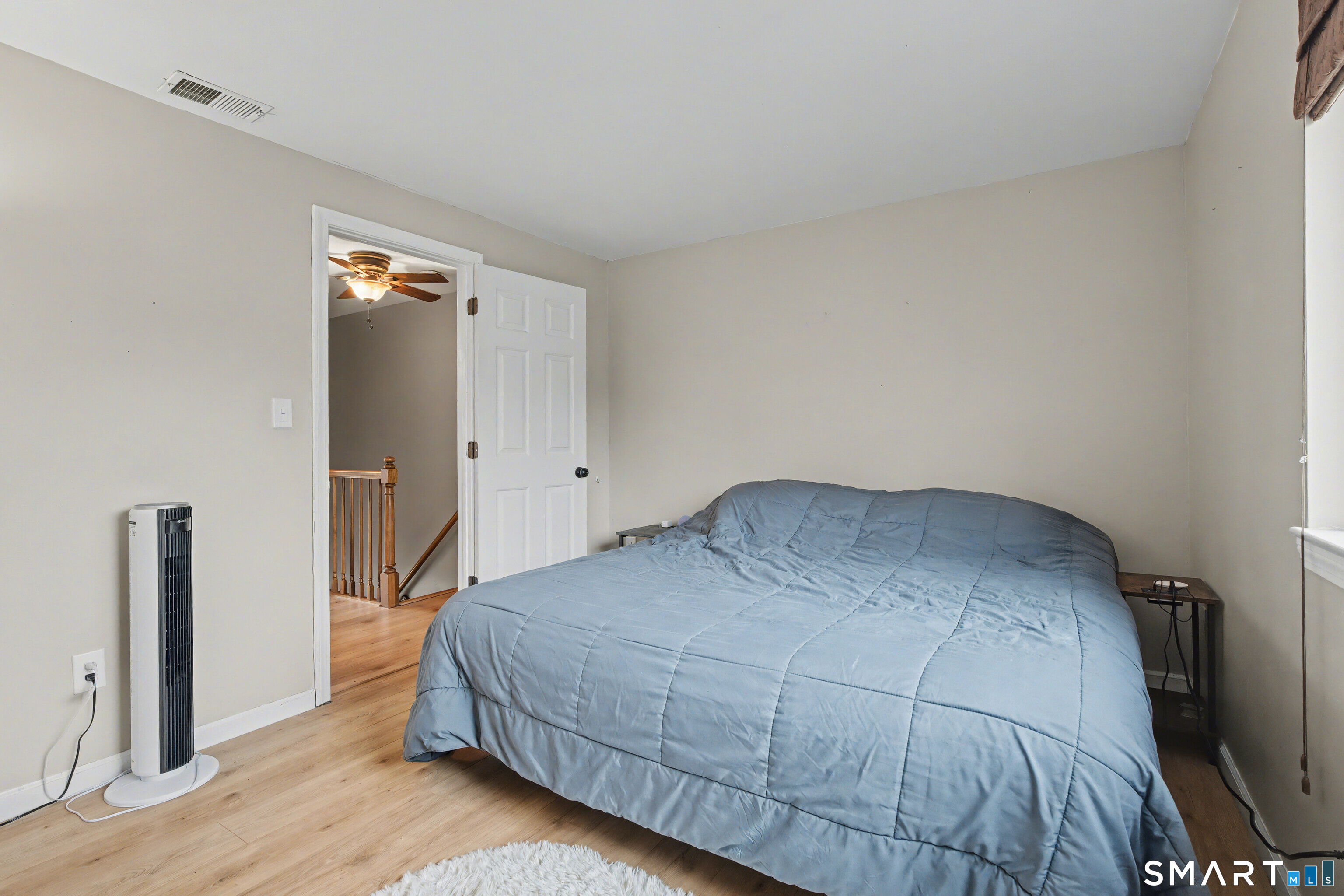 120 West Main Street, Unit 206 Meriden, CT 06451 - Photo 21 of 37 a bedroom with a bed and wooden floor