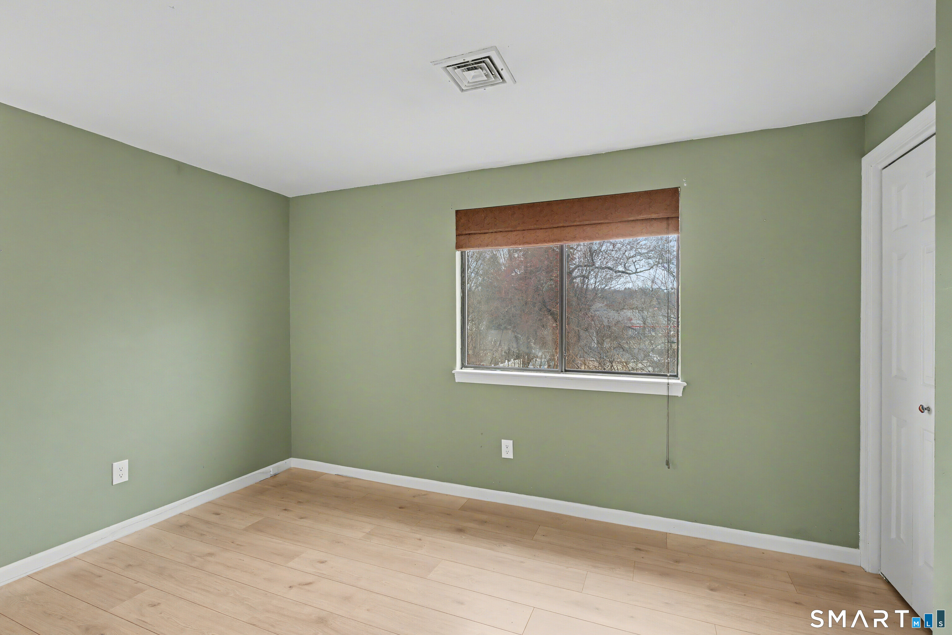 120 West Main Street, Unit 206 Meriden, CT 06451 - Photo 23 of 37 a view of an empty room with wooden floor and a window