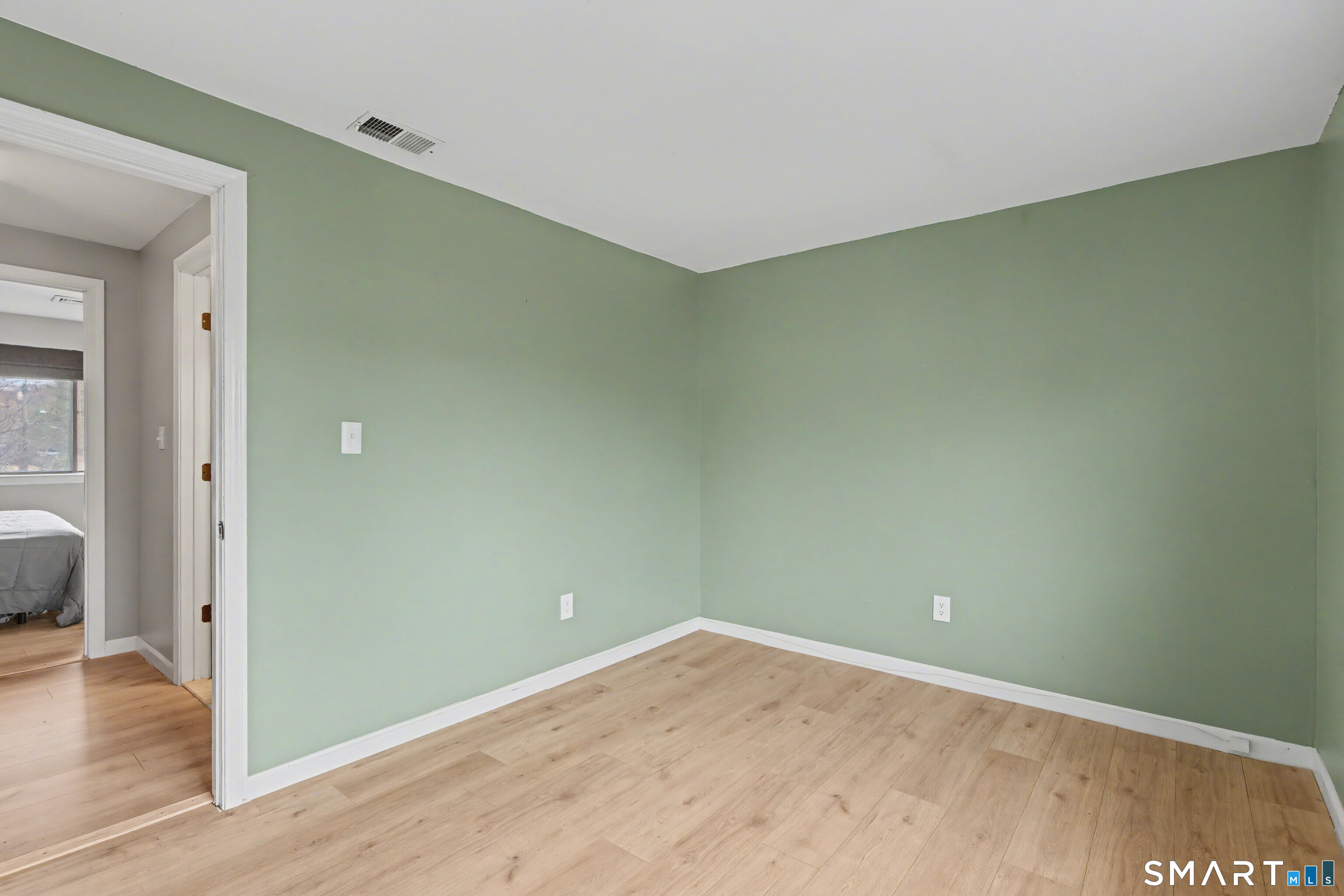 120 West Main Street, Unit 206 Meriden, CT 06451 - Photo 25 of 37 an empty room with wooden floor and a window