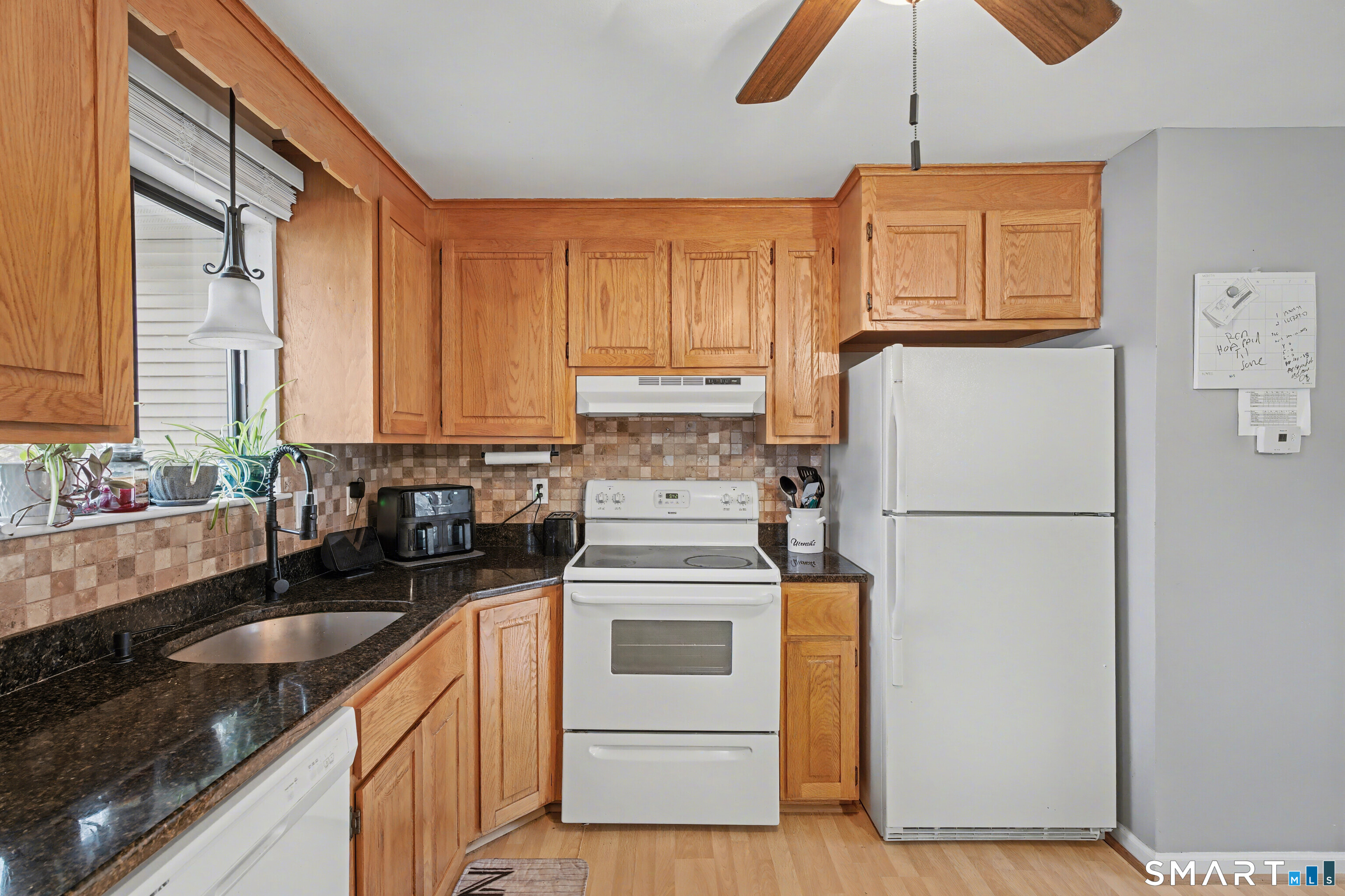 120 West Main Street, Unit 206 Meriden, CT 06451 - Photo 9 of 37 a kitchen with stainless steel appliances a refrigerator sink and cabinets