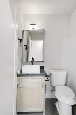 a view of empty room with wooden floor and ceiling fan