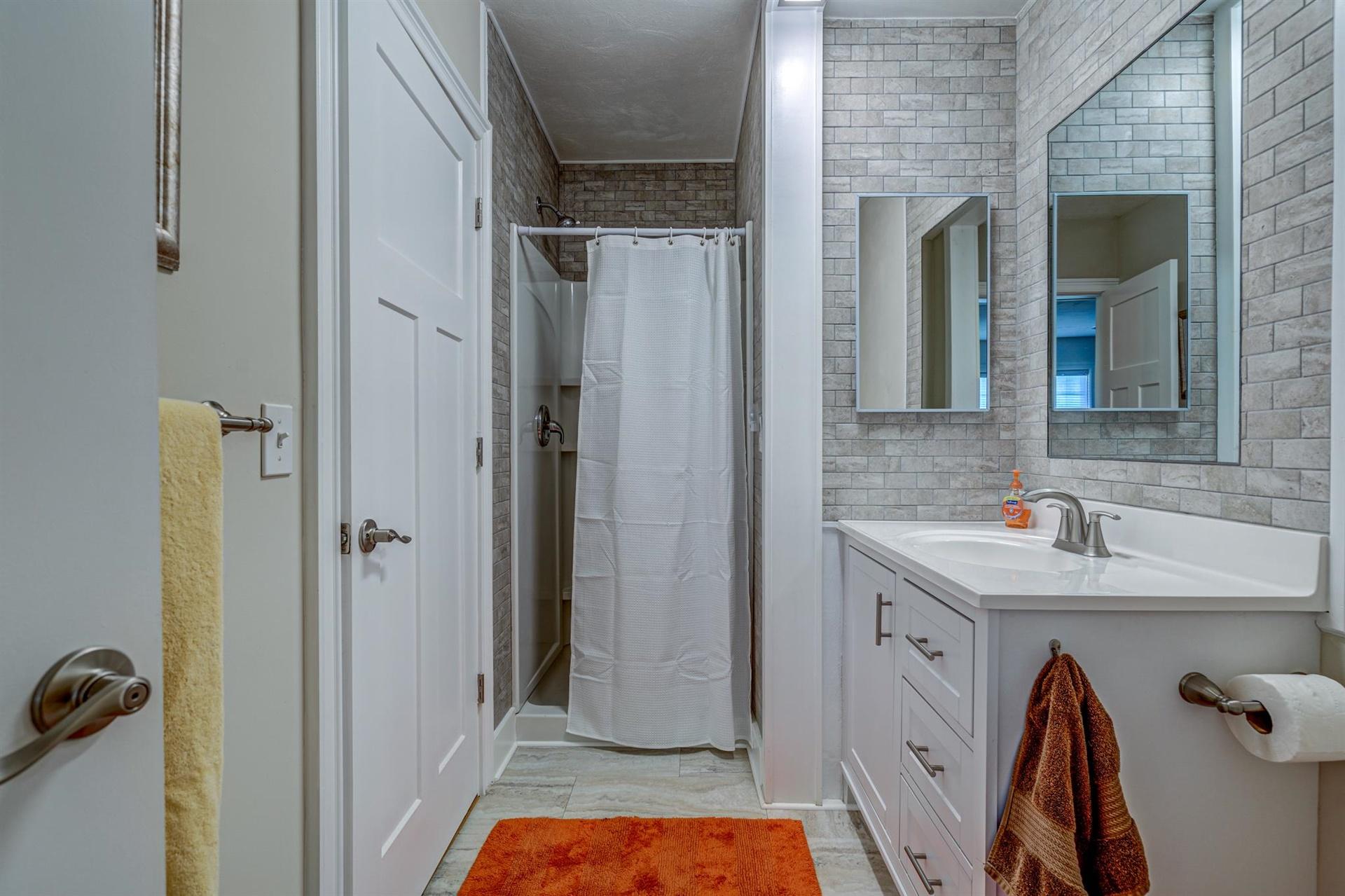 279 Morgans Fork Road, Unit 301 Penhook, VA 24137 - Photo 14 of 52 a bathroom with a sink and a mirror