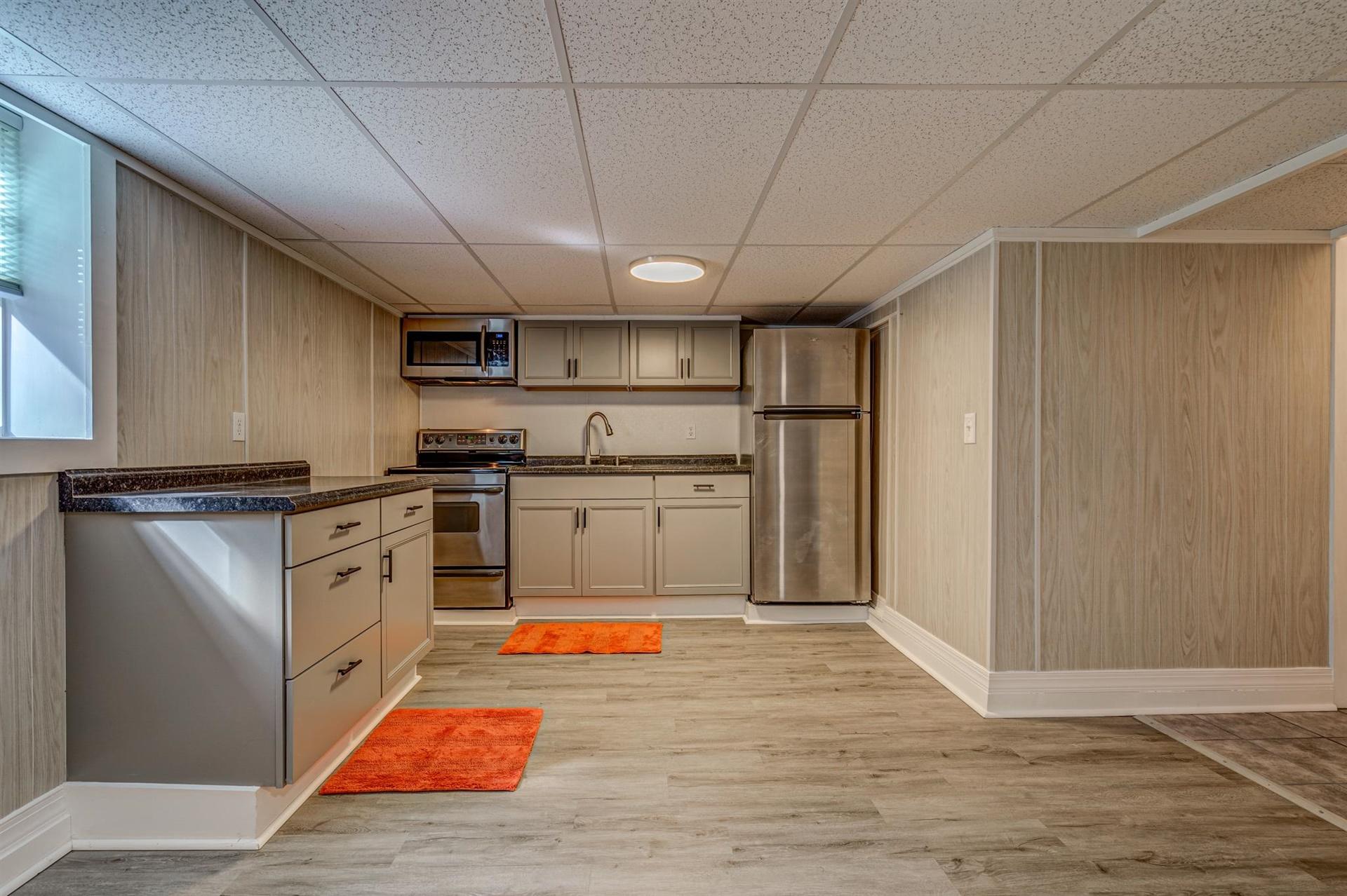 279 Morgans Fork Road, Unit 301 Penhook, VA 24137 - Photo 22 of 52 a kitchen with stainless steel appliances granite countertop a refrigerator a sink dishwasher a stove with wooden cabinets and floor