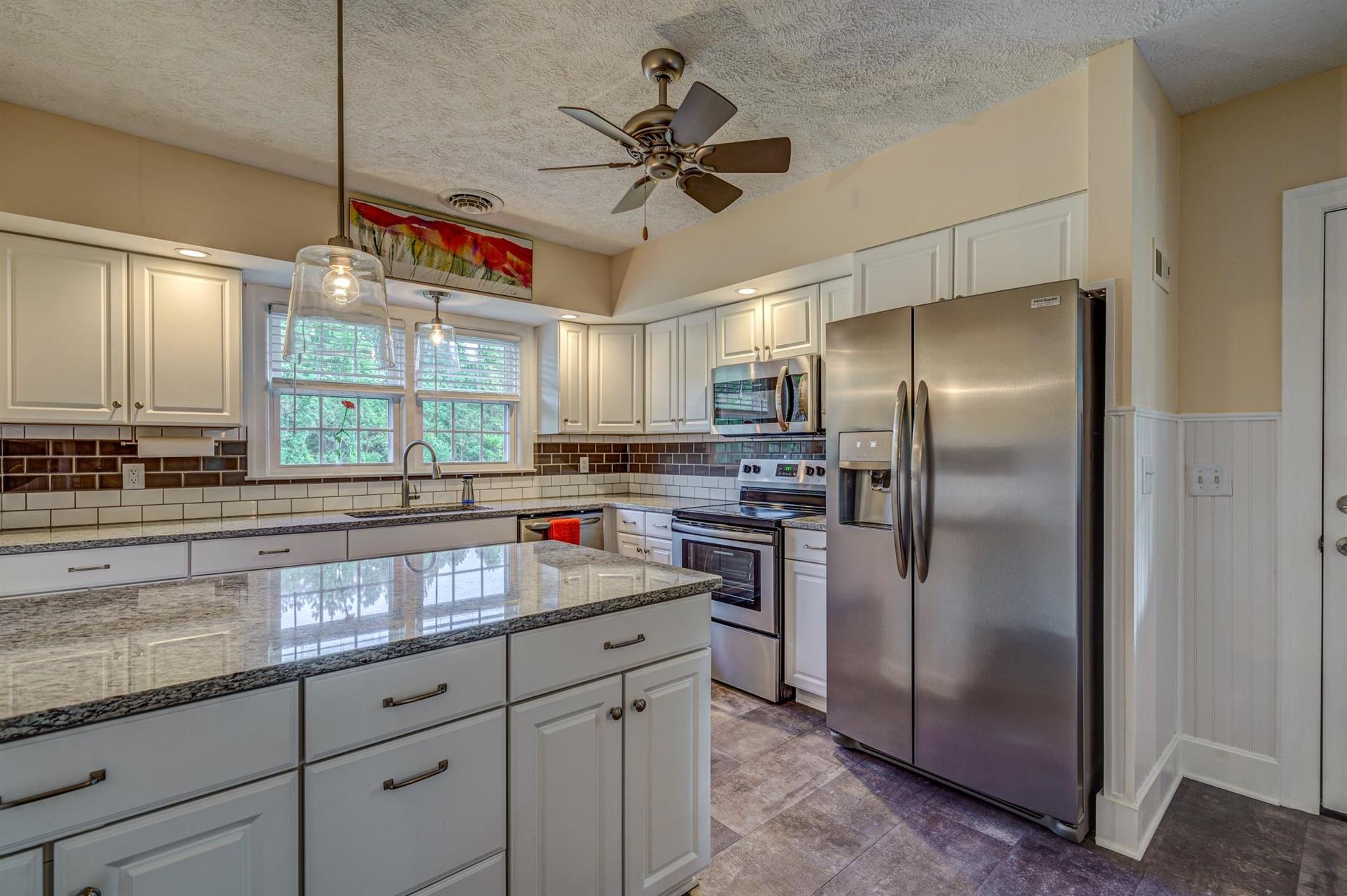 279 Morgans Fork Road, Unit 301 Penhook, VA 24137 - Photo 7 of 52 a kitchen with stainless steel appliances granite countertop a sink a refrigerator and a counter space