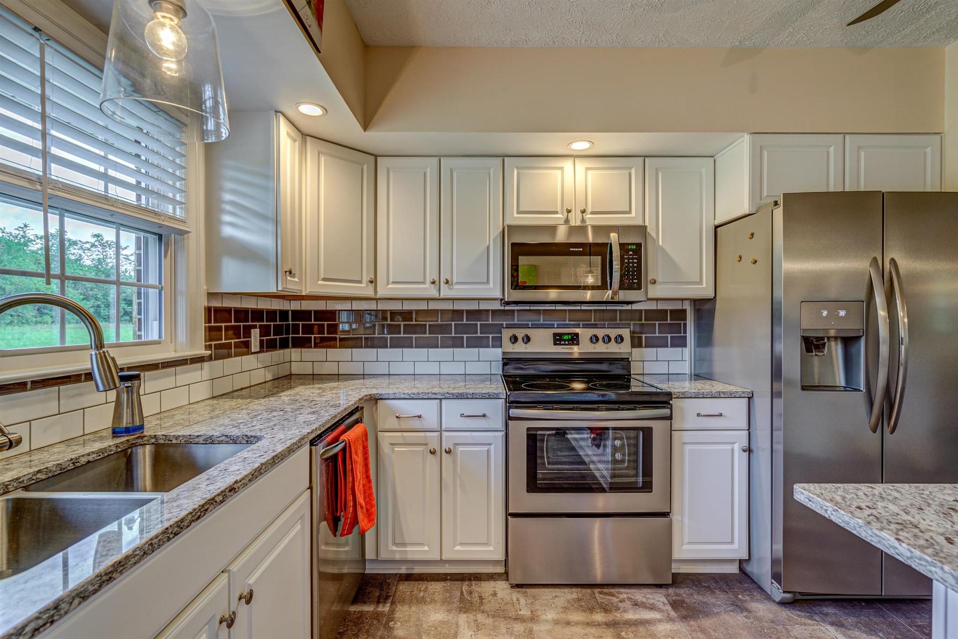 279 Morgans Fork Road, Unit 301 Penhook, VA 24137 - Photo 9 of 52 a kitchen with stainless steel appliances granite countertop a sink stove and refrigerator