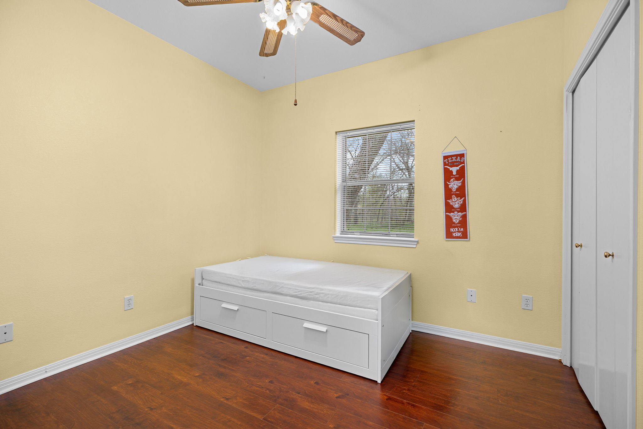 75 County Road 129 Taylor, TX 76574 - Photo 13 of 40 Bedroom with ceiling fan, dark wood finished floors, and a closet