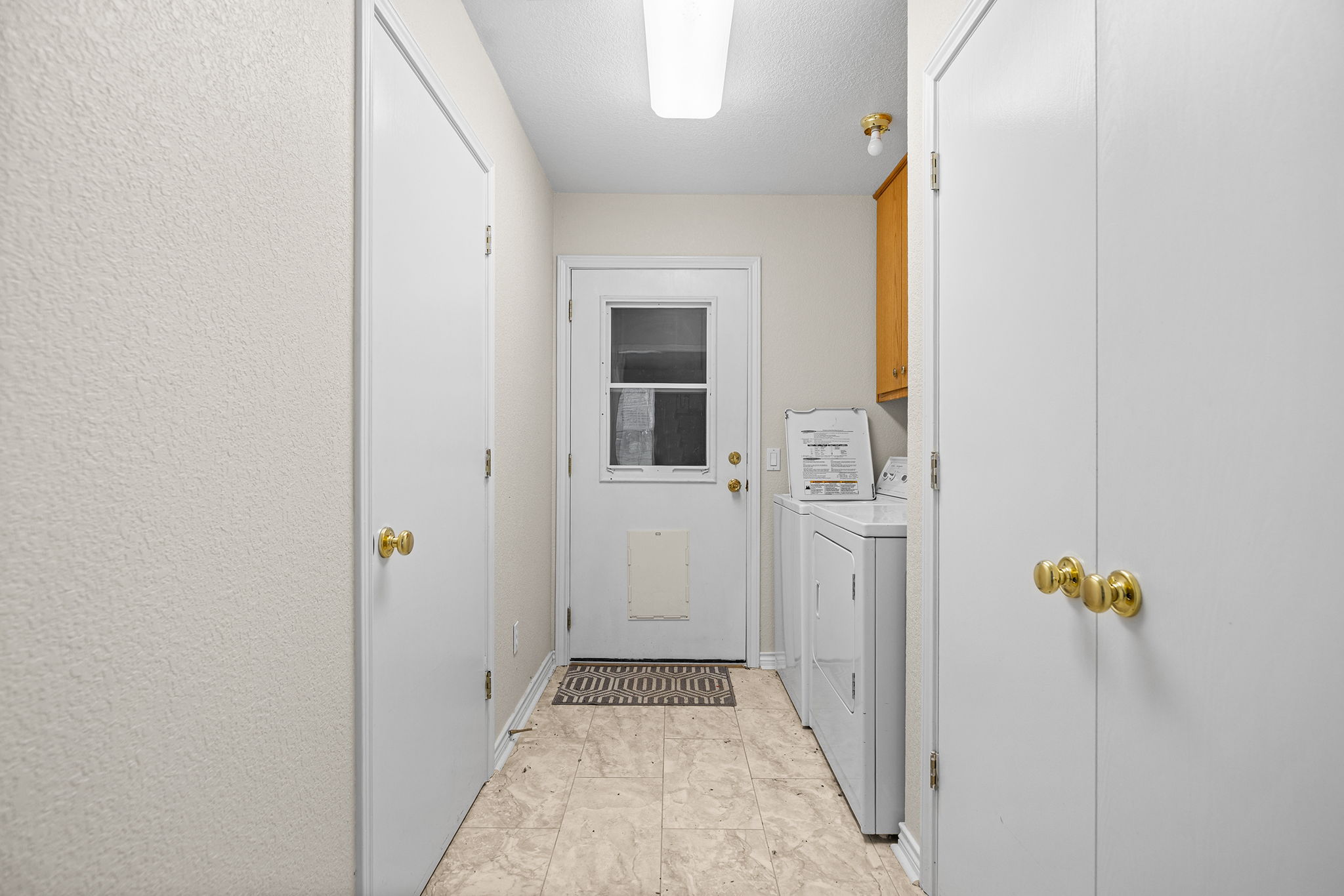 75 County Road 129 Taylor, TX 76574 - Photo 18 of 40 Laundry room featuring cabinet space, independent washer and dryer, and a textured wall