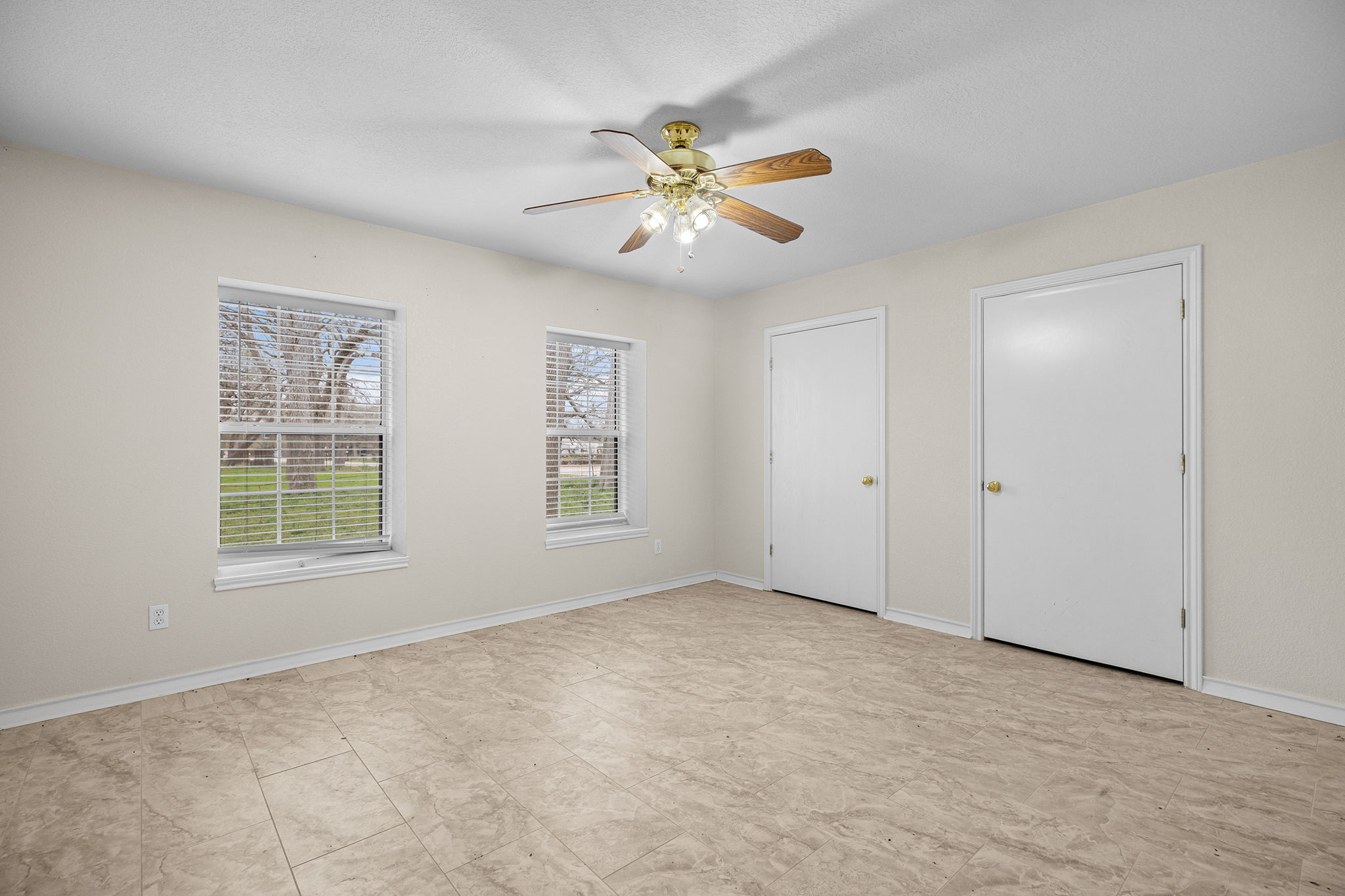 75 County Road 129 Taylor, TX 76574 - Photo 27 of 40 Unfurnished bedroom with ceiling fan and two closets