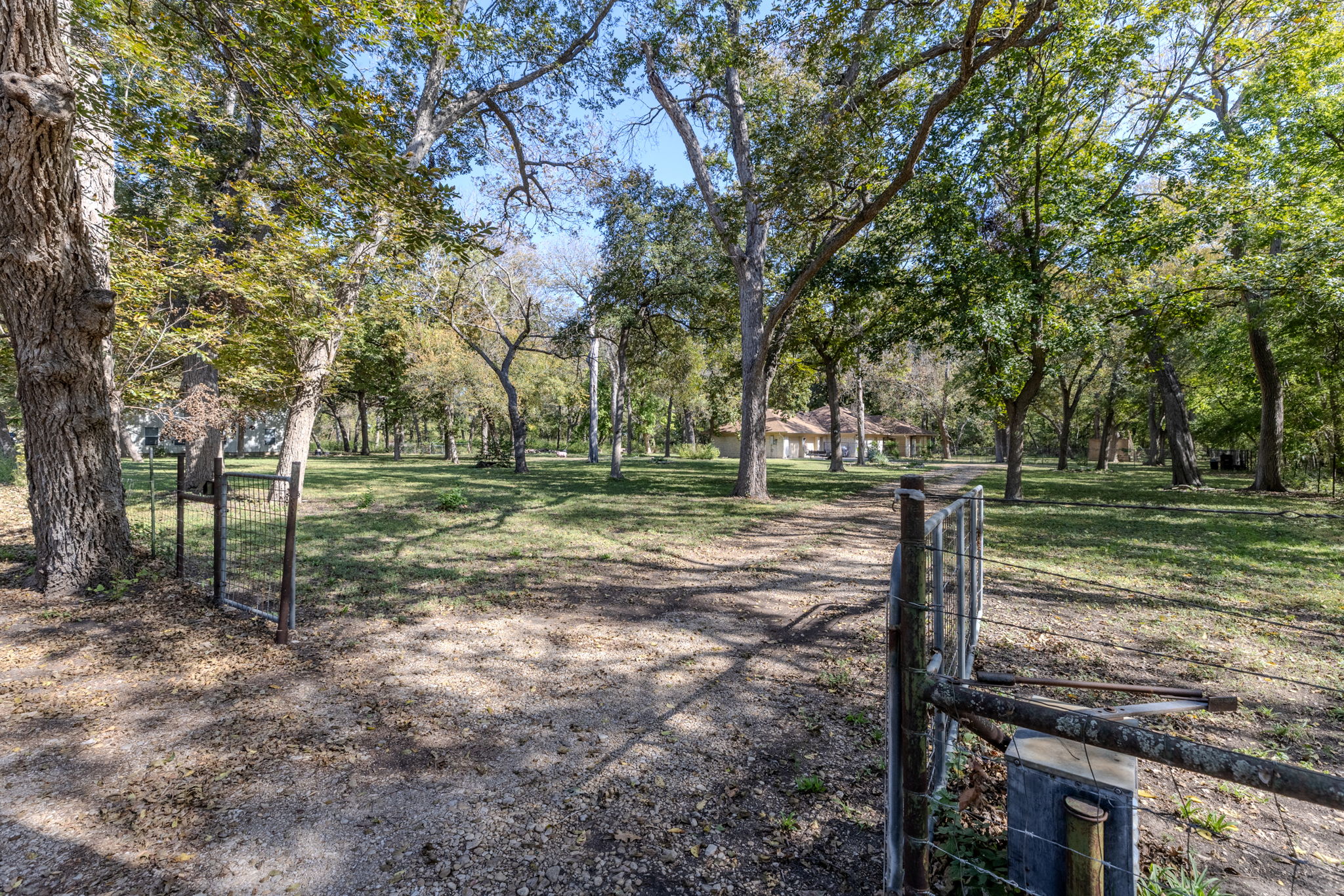 75 County Road 129 Taylor, TX 76574 - Photo 33 of 40 View of home's community with a gate and view of wooded area