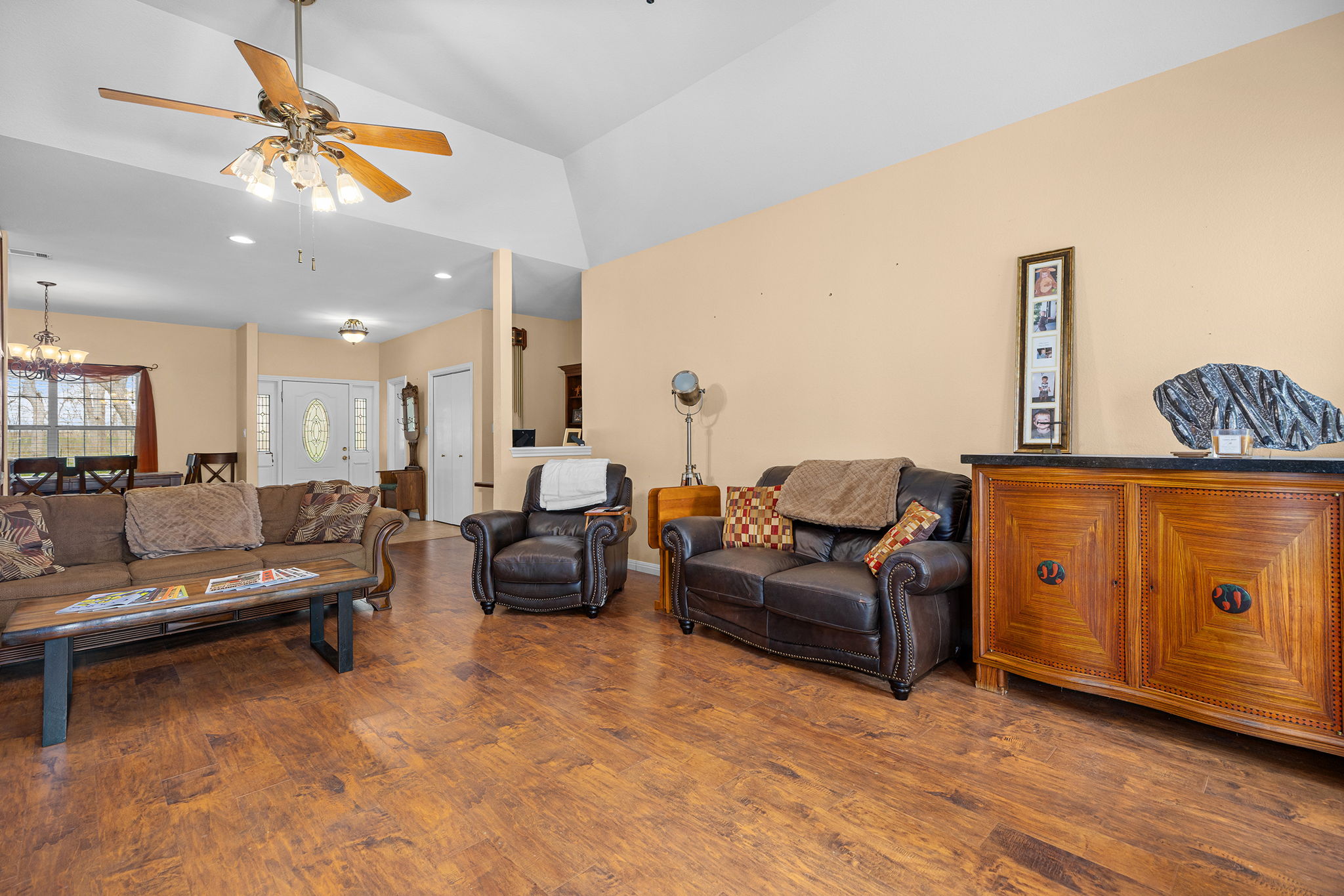 75 County Road 129 Taylor, TX 76574 - Photo 4 of 40 Living room with ceiling fan, dark wood finished floors, hanging lights, and vaulted ceiling