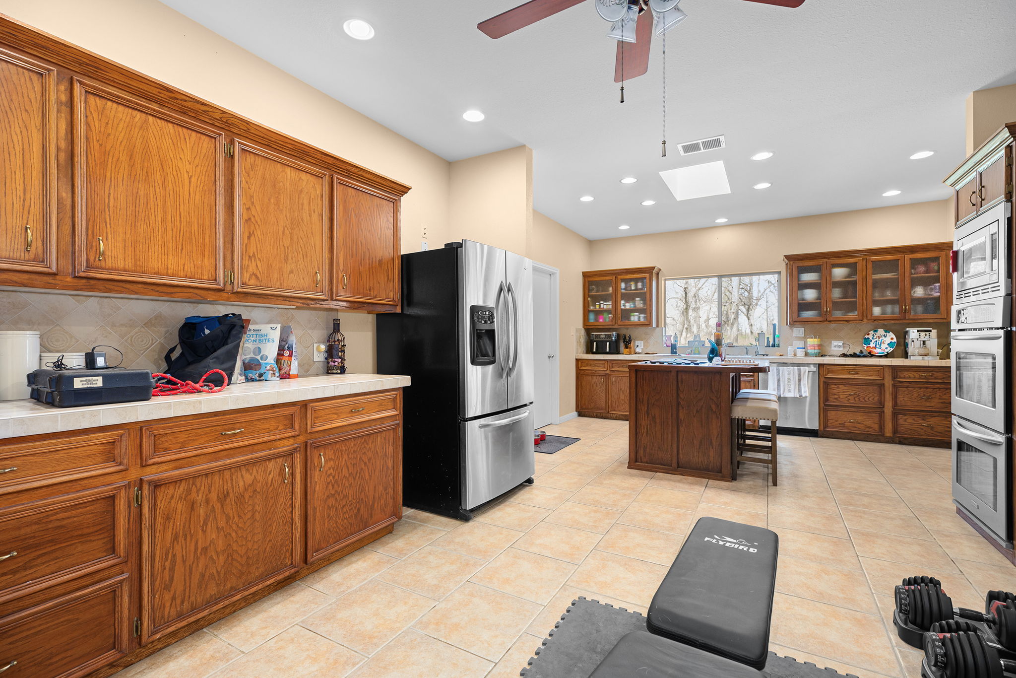 75 County Road 129 Taylor, TX 76574 - Photo 5 of 40 Kitchen featuring wood finish cabinetry, a skylight, light countertops, stainless steel appliances, and recessed lighting