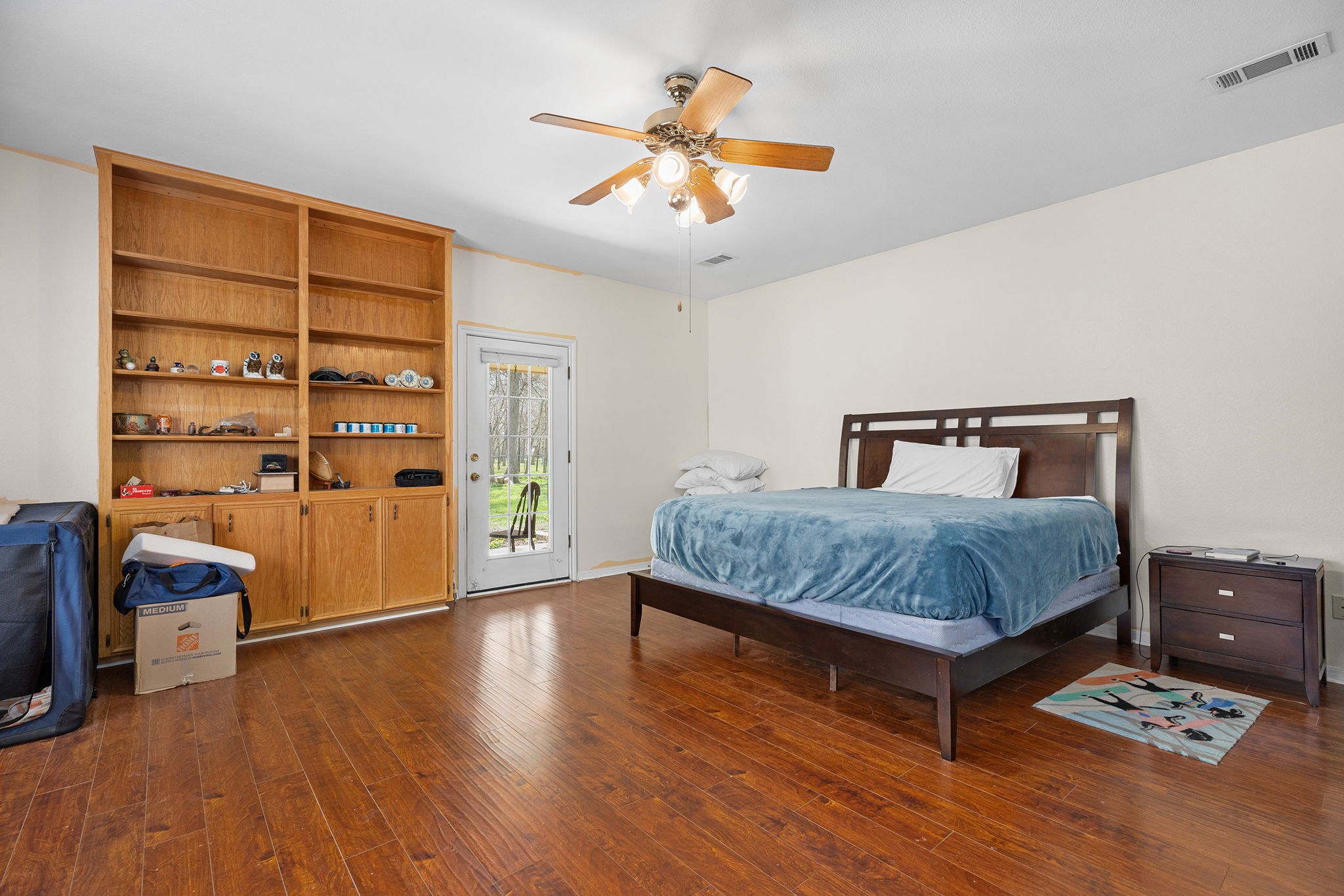 75 County Road 129 Taylor, TX 76574 - Photo 10 of 40 Bedroom featuring access to exterior, dark wood finished floors, and ceiling fan