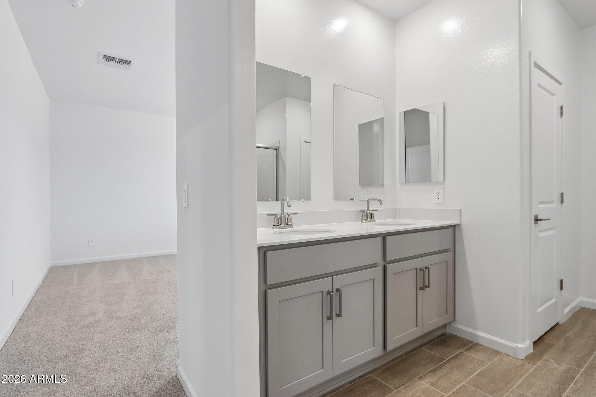 9544 West Gaby Road Tolleson, AZ 85353 - Photo 14 of 43 a bathroom with a double vanity sink and a mirror