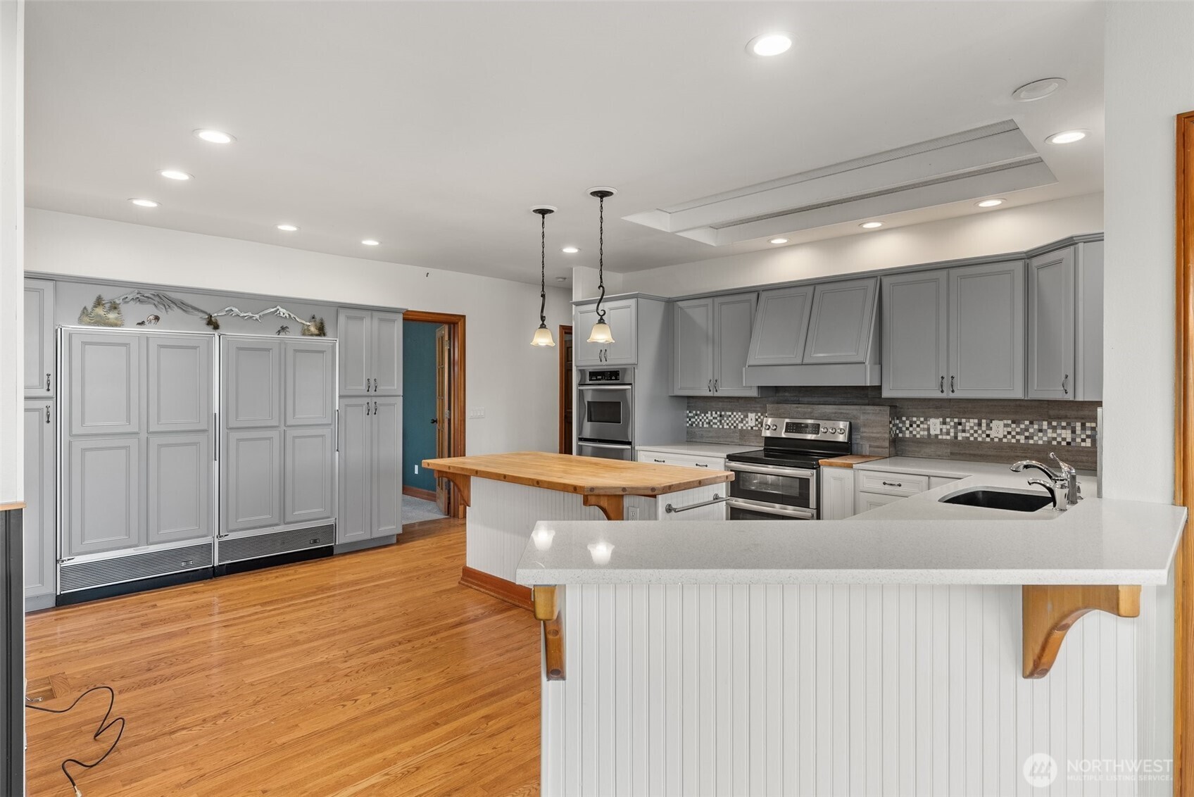 153 A Walhaupt Road Onalaska, WA 98570 - Photo 11 of 38 a kitchen with stainless steel appliances granite countertop a sink a stove a refrigerator cabinets and chairs