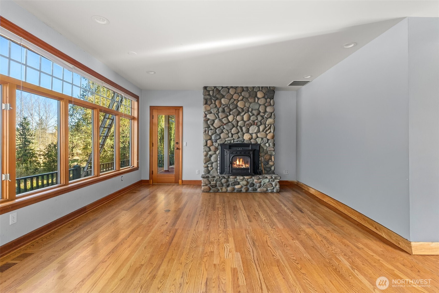 153 A Walhaupt Road Onalaska, WA 98570 - Photo 7 of 38 a view of an empty room with a fireplace and a window