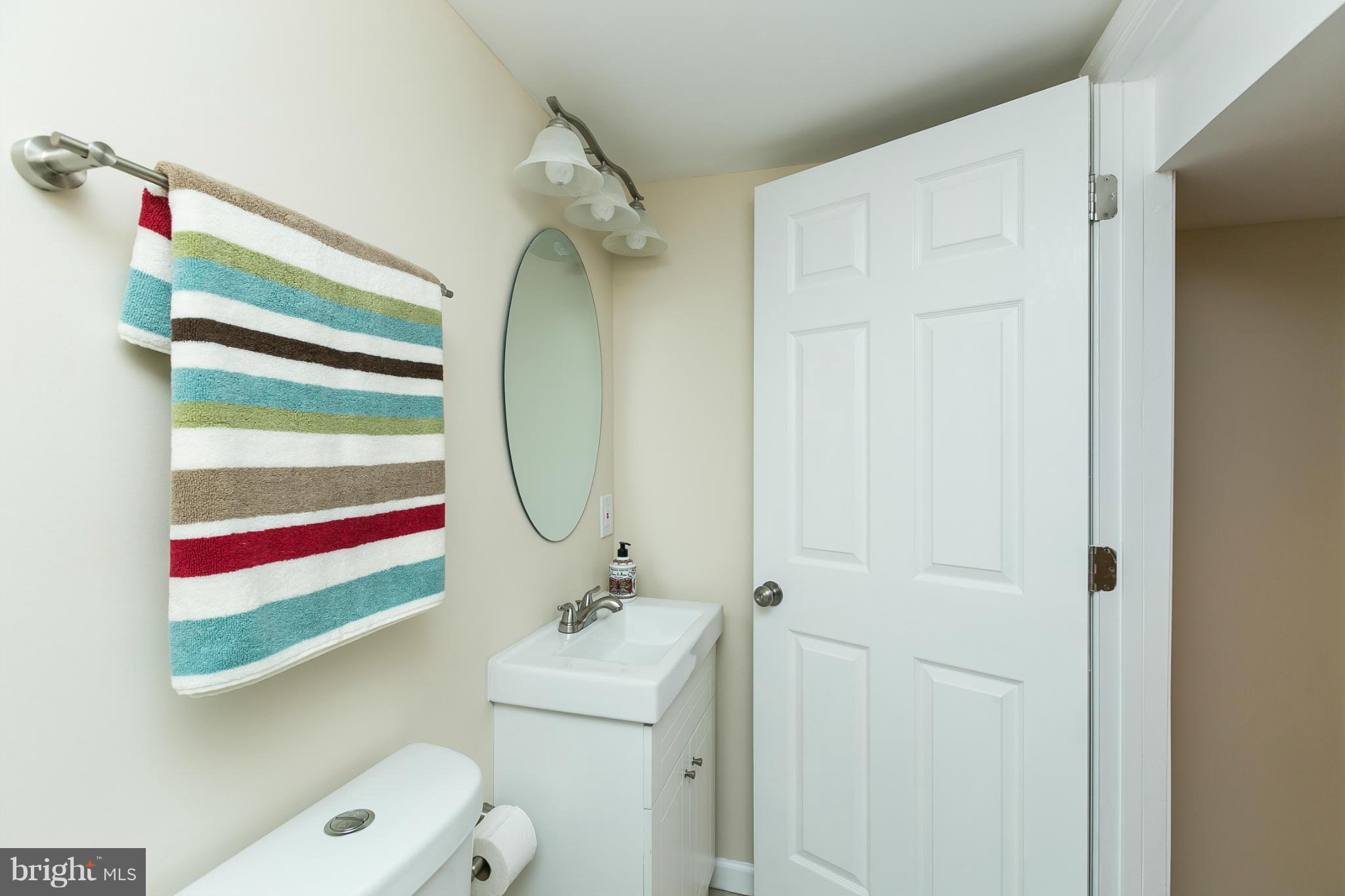 4122 Essex Road Baltimore, MD 21207 - Photo 11 of 30 a bathroom with a sink and mirror with toilet