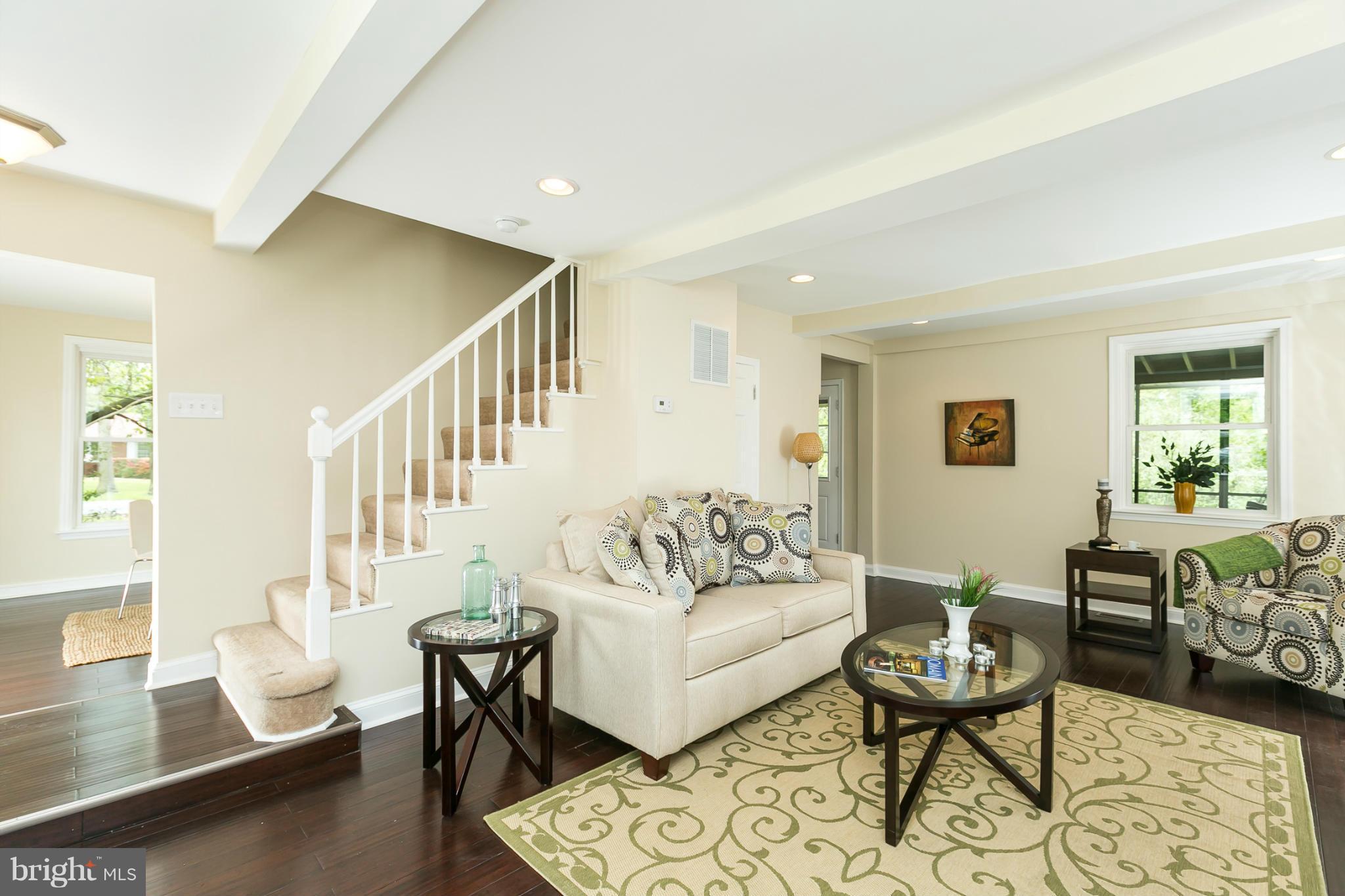 4122 Essex Road Baltimore, MD 21207 - Photo 12 of 30 a living room with furniture and a table with wooden floor