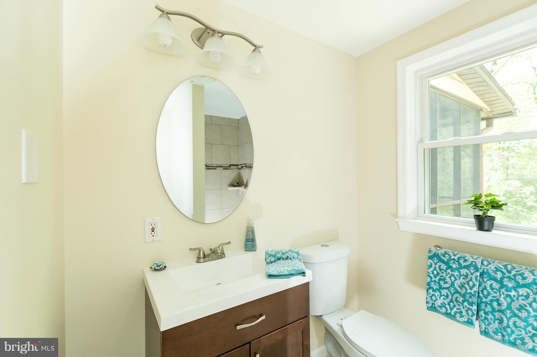 4122 Essex Road Baltimore, MD 21207 - Photo 17 of 30 a bathroom with a sink toilet and a mirror