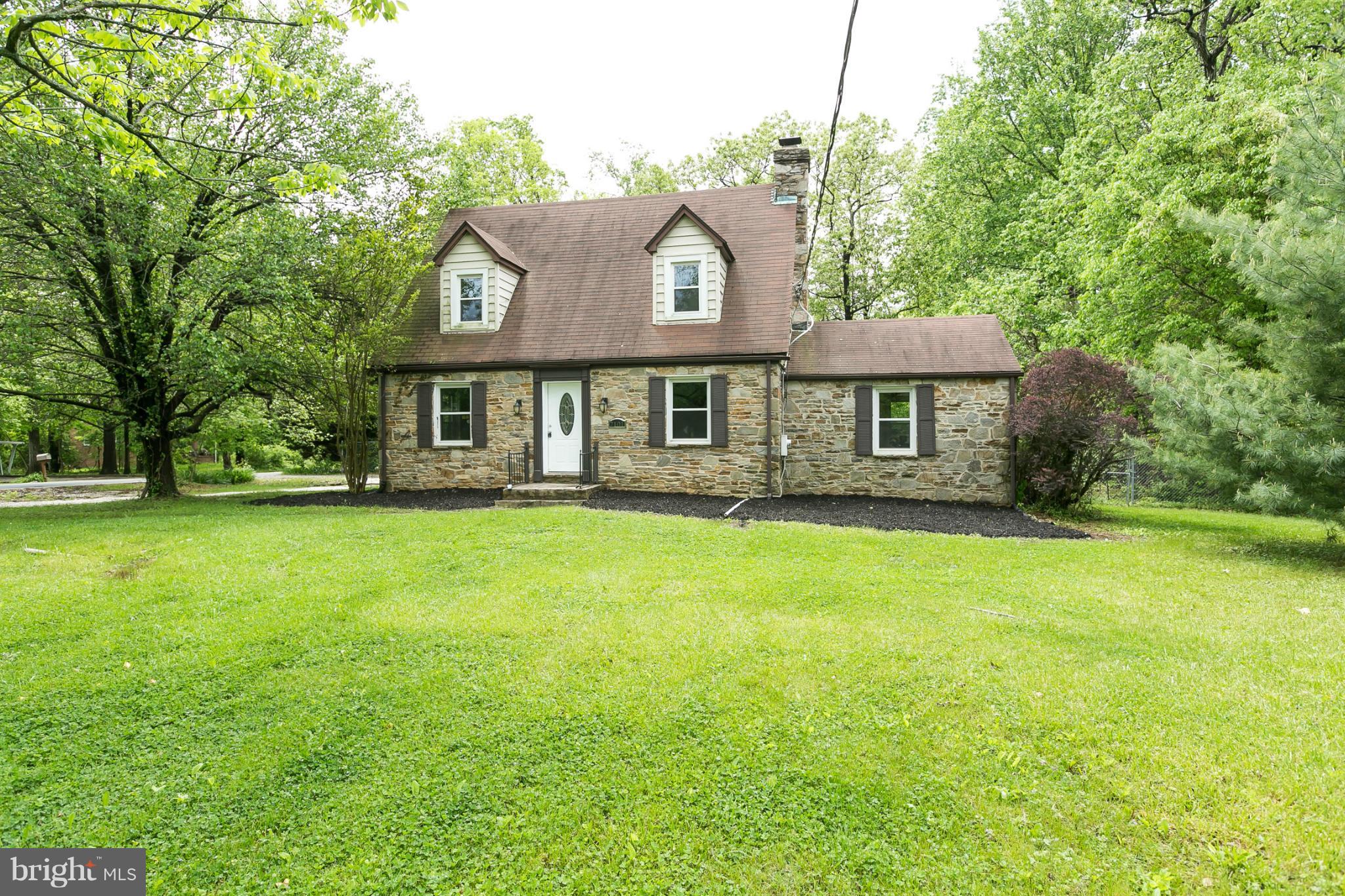 4122 Essex Road Baltimore, MD 21207 - Photo 26 of 30 a front view of a house with a garden