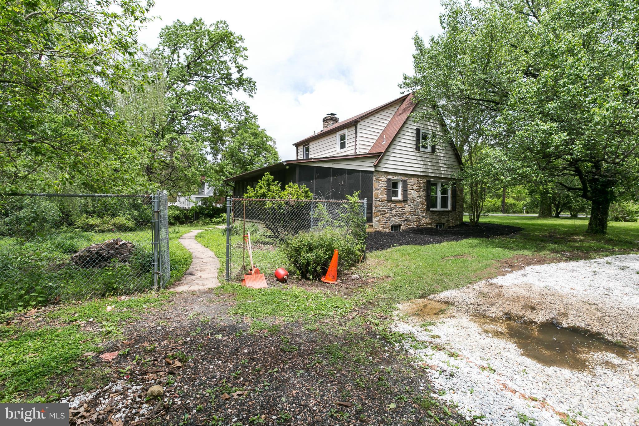 4122 Essex Road Baltimore, MD 21207 - Photo 28 of 30 a view of house with a big yard and large trees