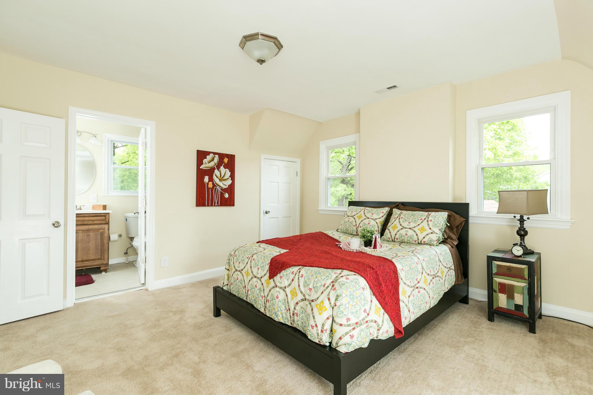 4122 Essex Road Baltimore, MD 21207 - Photo 4 of 30 a bedroom with a bed and a table in it