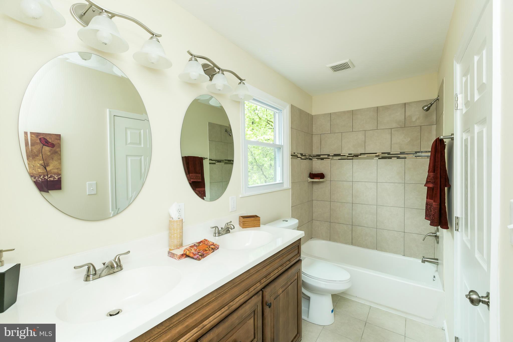 4122 Essex Road Baltimore, MD 21207 - Photo 5 of 30 a bathroom with a sink a toilet and shower