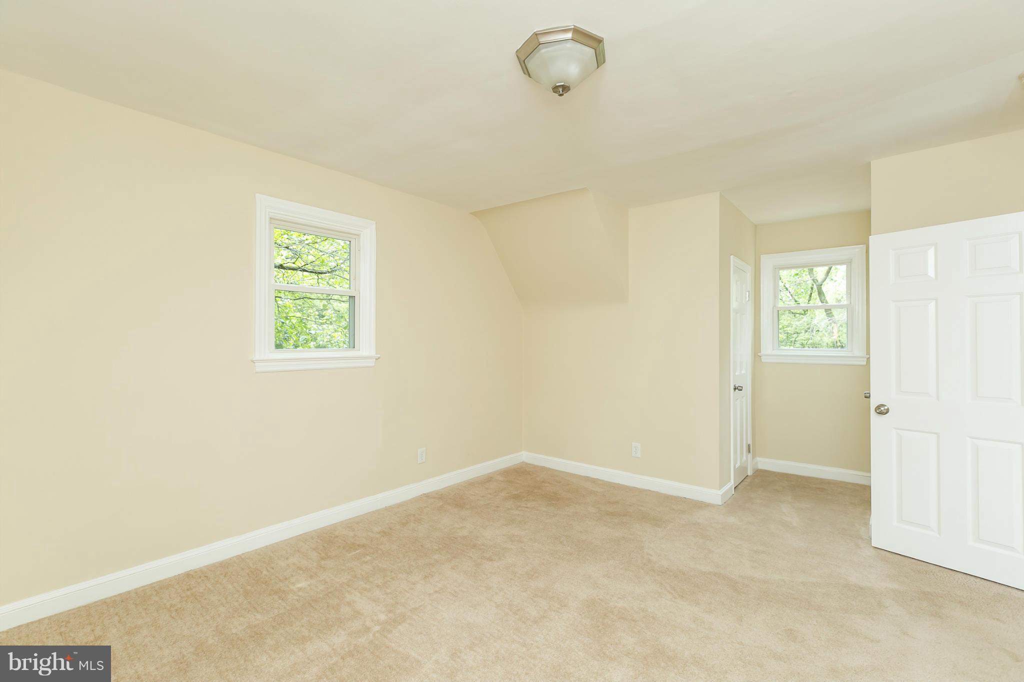 4122 Essex Road Baltimore, MD 21207 - Photo 9 of 30 an empty room with windows