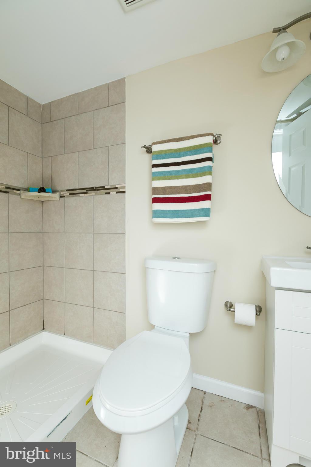 4122 Essex Road Baltimore, MD 21207 - Photo 10 of 30 a bathroom with a toilet and a sink