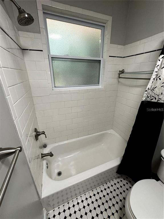 320 North Rhodes Street Mount Dora, FL 32757 - Photo 11 of 33 a bathroom with a bathtub and a shower