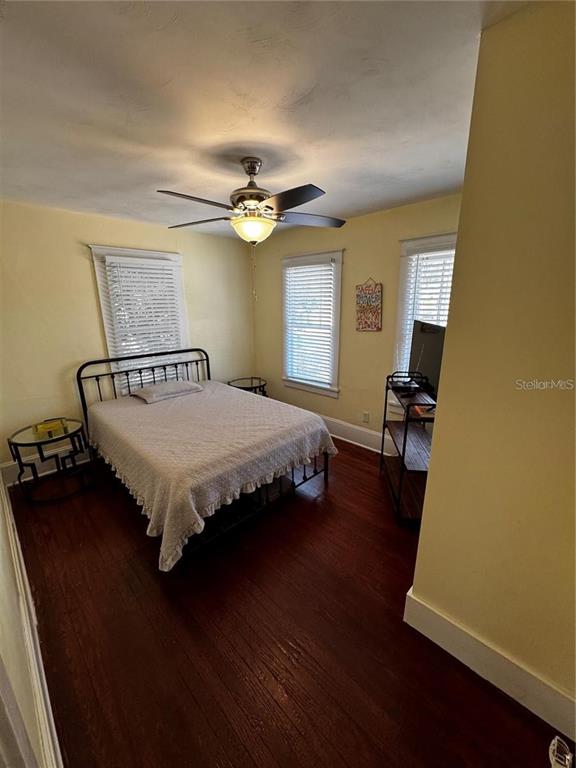 320 North Rhodes Street Mount Dora, FL 32757 - Photo 12 of 33 a bedroom with a bed dresser and wooden floor