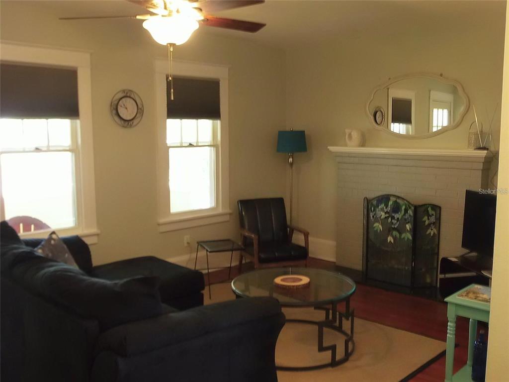 320 North Rhodes Street Mount Dora, FL 32757 - Photo 25 of 33 a living room with furniture and a fireplace
