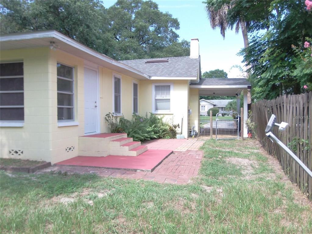 320 North Rhodes Street Mount Dora, FL 32757 - Photo 26 of 33 a view of a house with backyard and sitting area