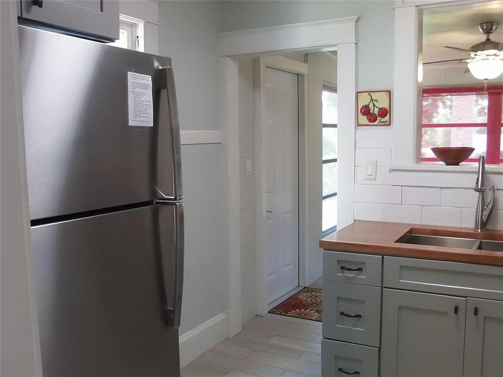320 North Rhodes Street Mount Dora, FL 32757 - Photo 28 of 33 a kitchen with a refrigerator and cabinets