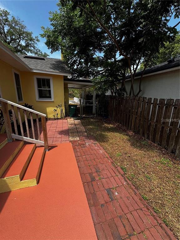 320 North Rhodes Street Mount Dora, FL 32757 - Photo 30 of 33 a view of a patio with table and chairs with wooden floor and fence