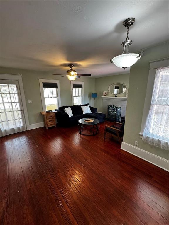 320 North Rhodes Street Mount Dora, FL 32757 - Photo 4 of 33 a living room with couches and kitchen view with wooden floor