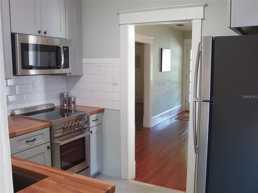 320 North Rhodes Street Mount Dora, FL 32757 - Photo 8 of 33 a kitchen with a stove microwave and refrigerator