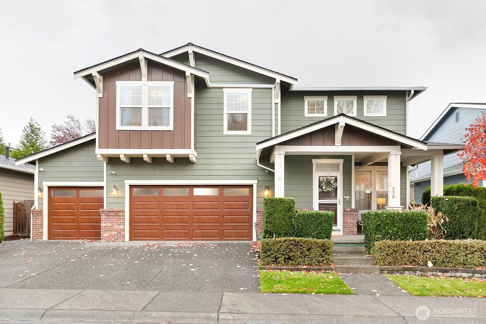 550 Pasco Place Northeast Renton, WA 98059 - Photo 1 of 32 a front view of a house with a yard and potted plants