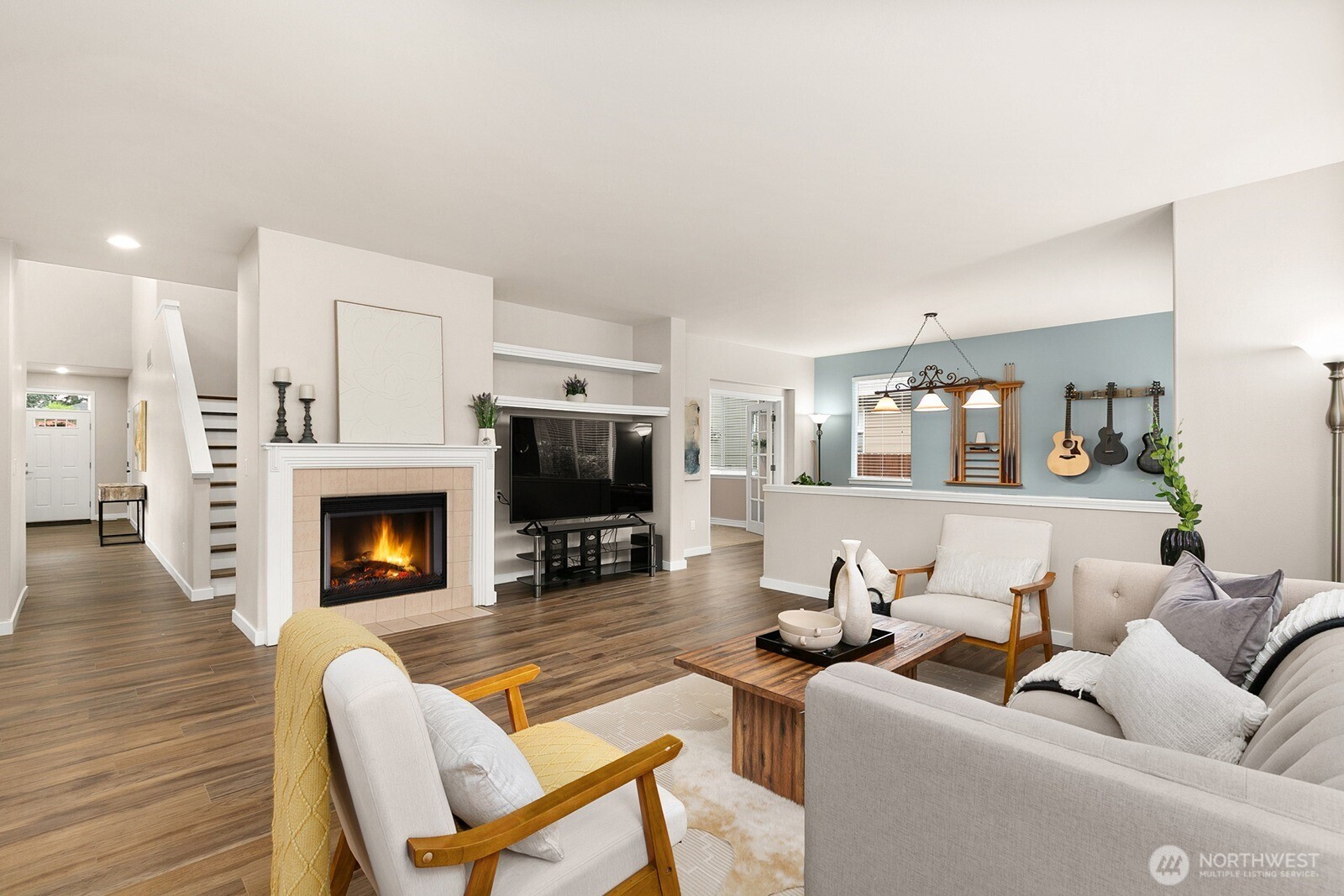 550 Pasco Place Northeast Renton, WA 98059 - Photo 11 of 32 a living room with furniture a fireplace and a flat screen tv