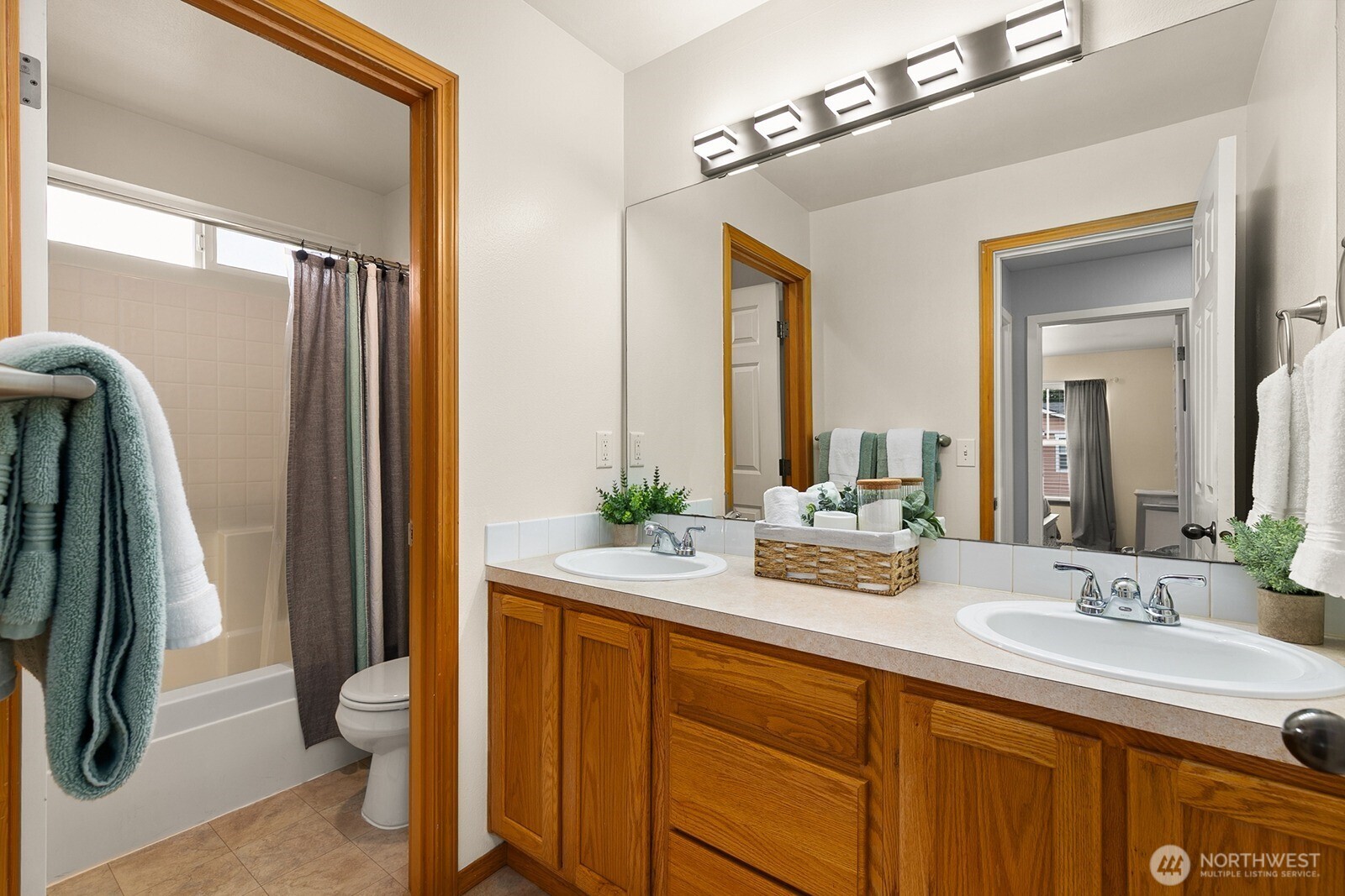 550 Pasco Place Northeast Renton, WA 98059 - Photo 26 of 32 a bathroom with a double vanity sink and a mirror