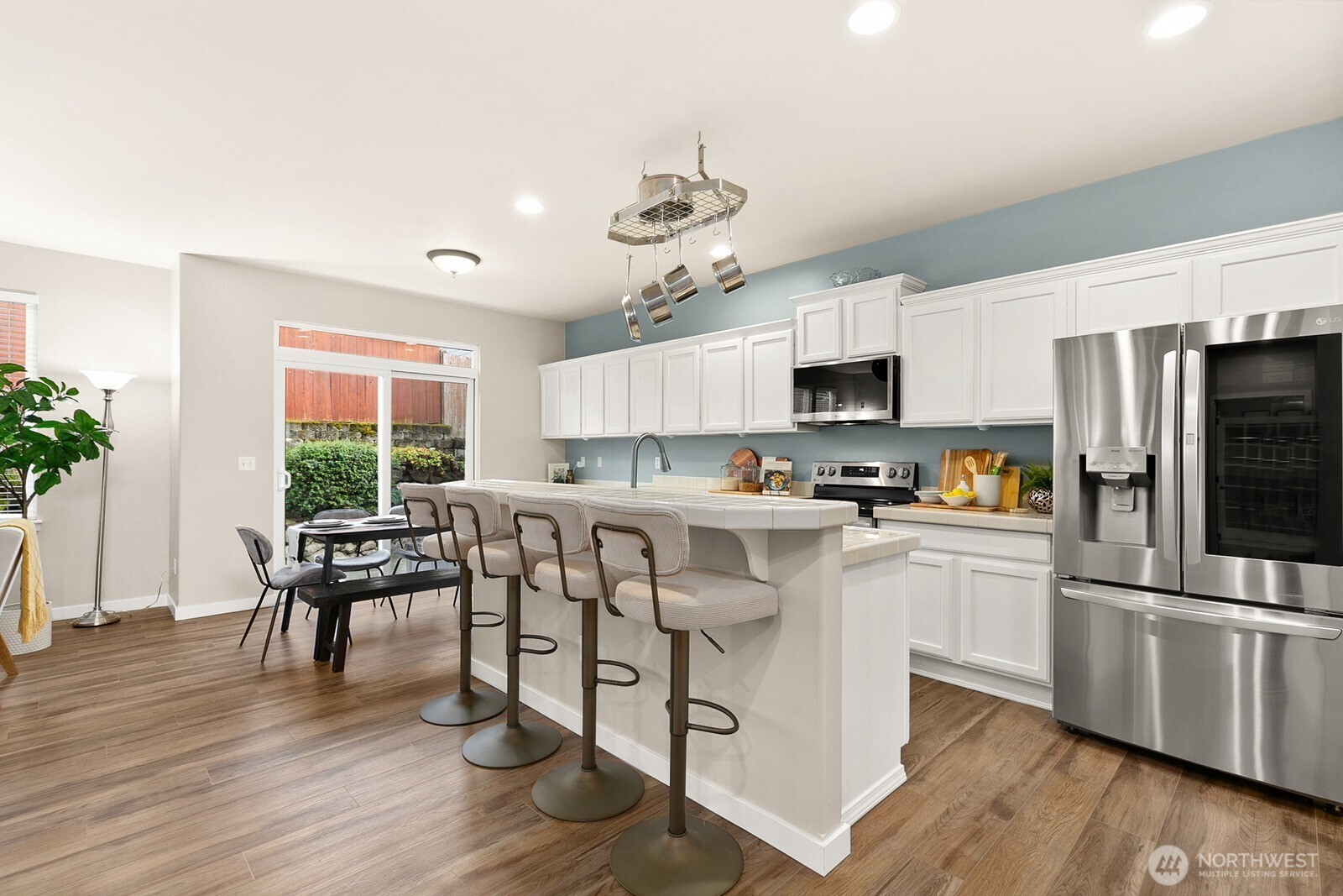 550 Pasco Place Northeast Renton, WA 98059 - Photo 8 of 32 a kitchen with white cabinets and stainless steel appliances