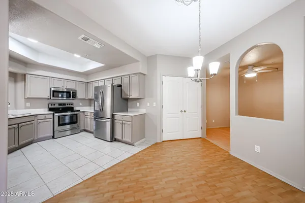 a kitchen with stainless steel appliances a refrigerator sink and stove