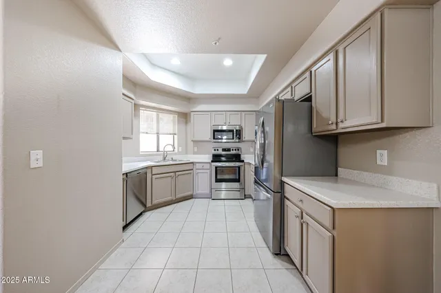 a kitchen with stainless steel appliances granite countertop a stove and a sink