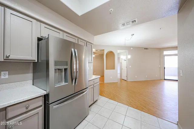 a kitchen with stainless steel appliances granite countertop a refrigerator and a stove