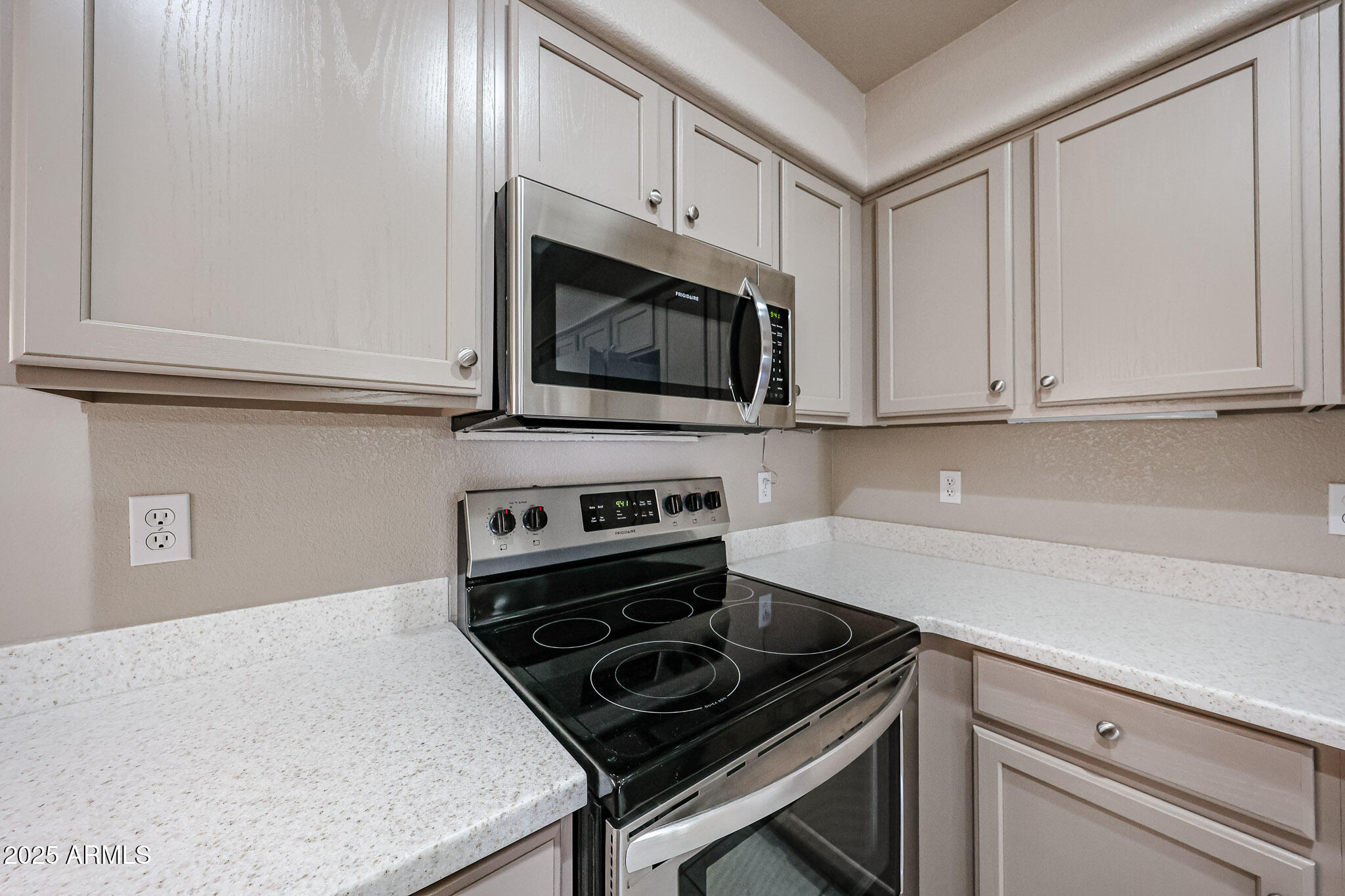 9151 West Greenway Road, Unit 162 Peoria, AZ 85381 - Photo 17 of 37 a kitchen with granite countertop white cabinets and stainless steel appliances