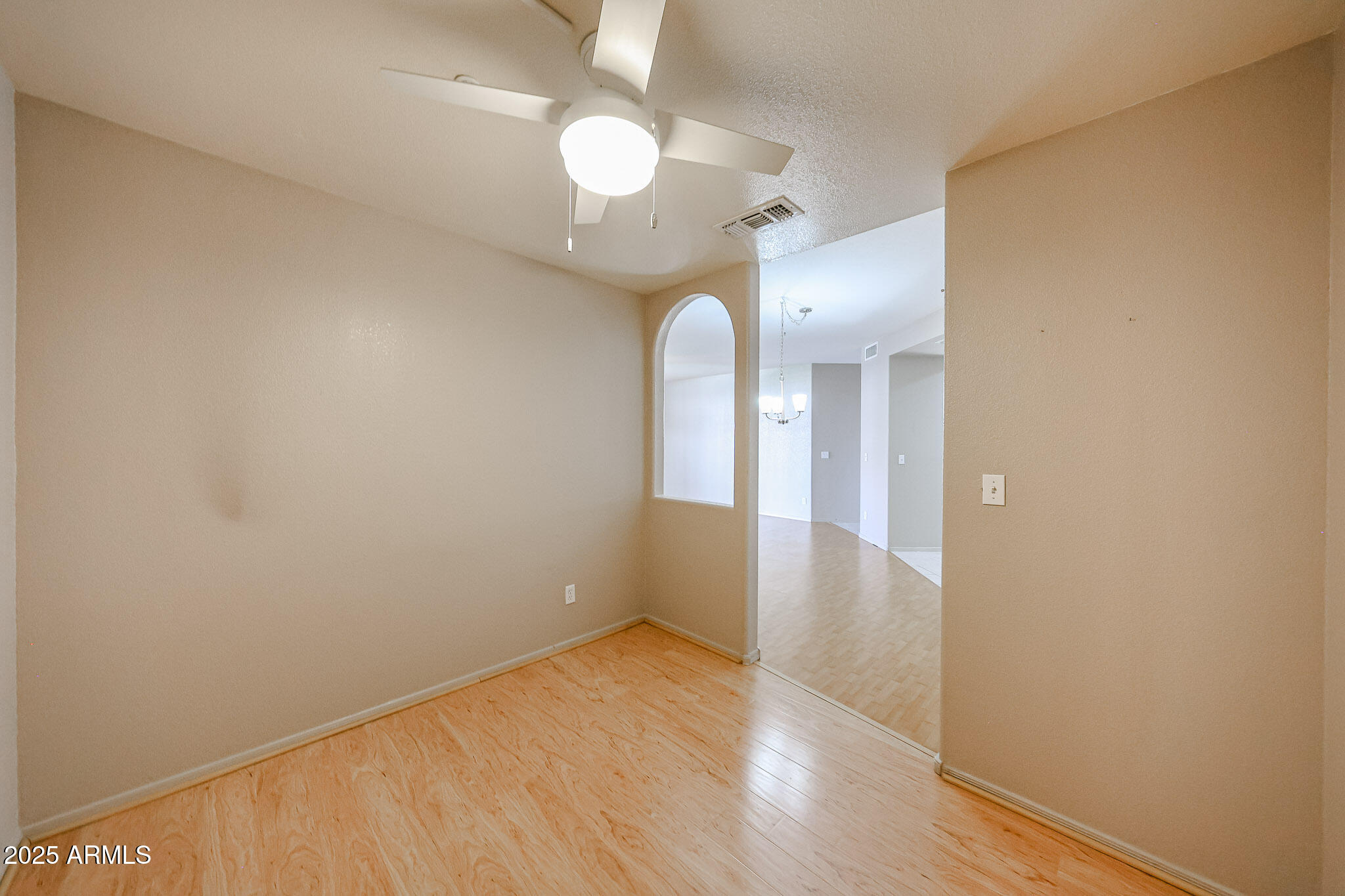 9151 West Greenway Road, Unit 162 Peoria, AZ 85381 - Photo 20 of 37 a view of a room with wooden floor and white walls
