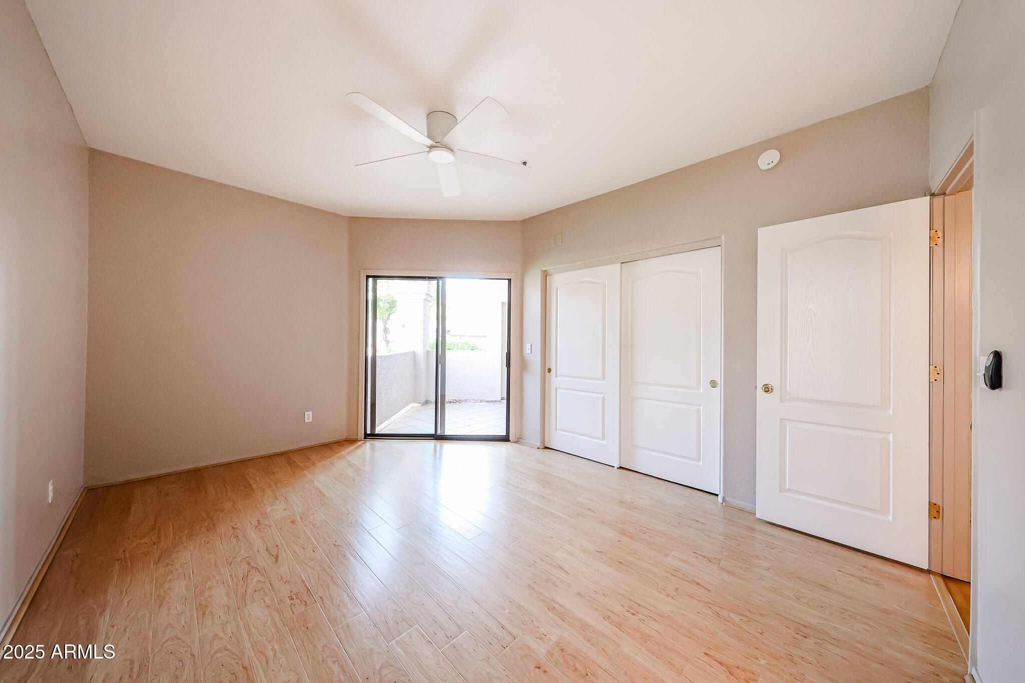 9151 West Greenway Road, Unit 162 Peoria, AZ 85381 - Photo 22 of 37 a view of an empty room with wooden floor and a window