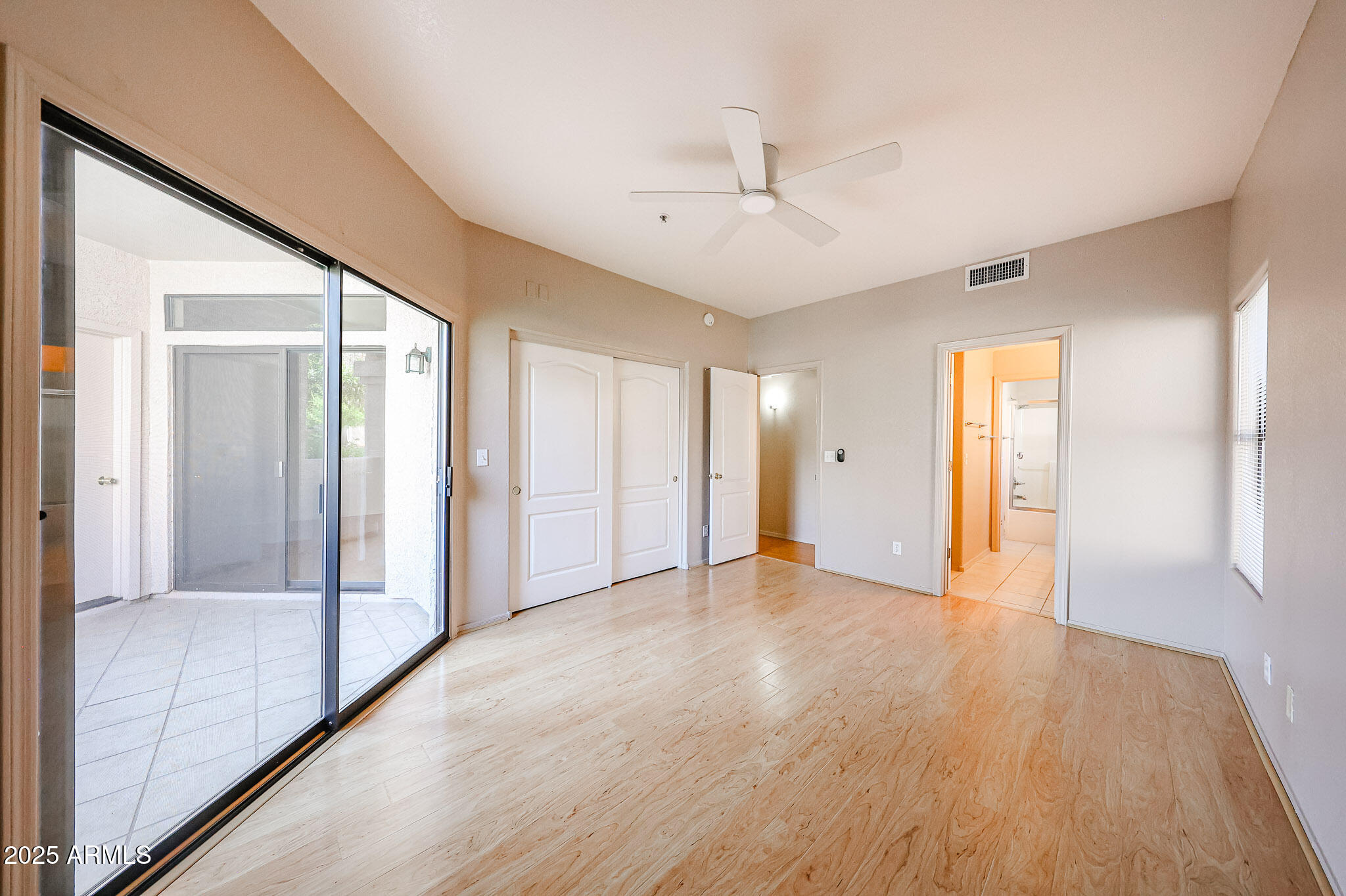9151 West Greenway Road, Unit 162 Peoria, AZ 85381 - Photo 23 of 37 a view of an empty room with wooden floor and a window