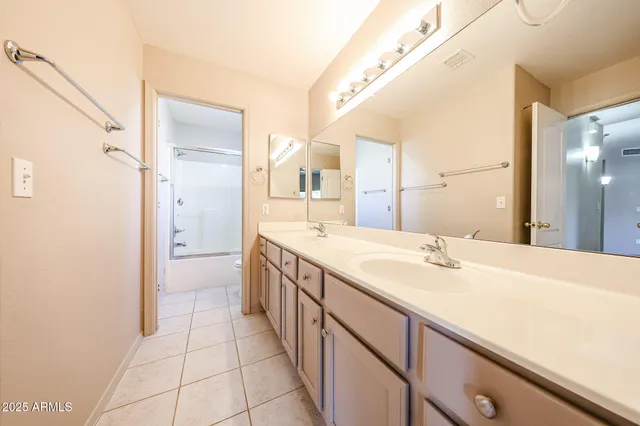 a spacious bathroom with a granite countertop sink and a mirror