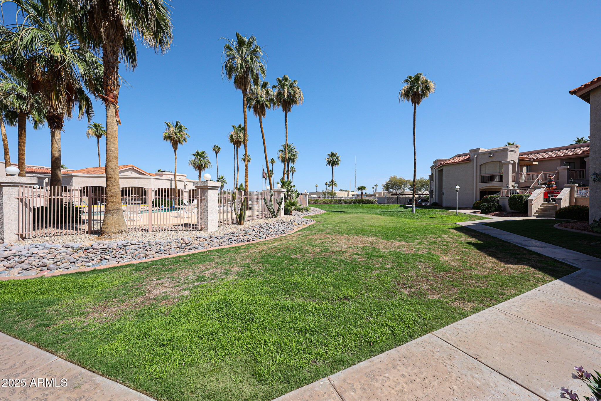 9151 West Greenway Road, Unit 162 Peoria, AZ 85381 - Photo 25 of 37 a view of a garden with a slide and a lake view
