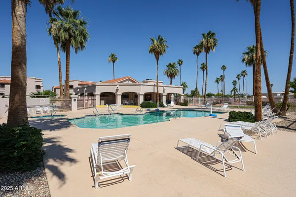 a swimming pool with outdoor seating and yard